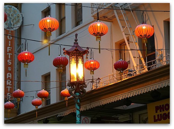 The lights are turning on at dusk in SF's Chinatown.