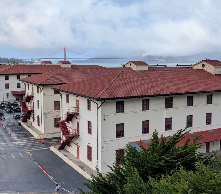 Views of the Golden Gate Bridge over the red roofs at the Fort Mason Center Views of the Golden Gate Bridge over the red roofs at the Fort Mason Center