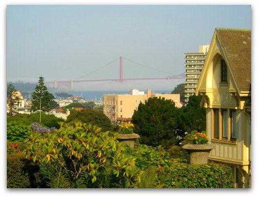 The golden gate bridge from far away with fog rolling in underneath