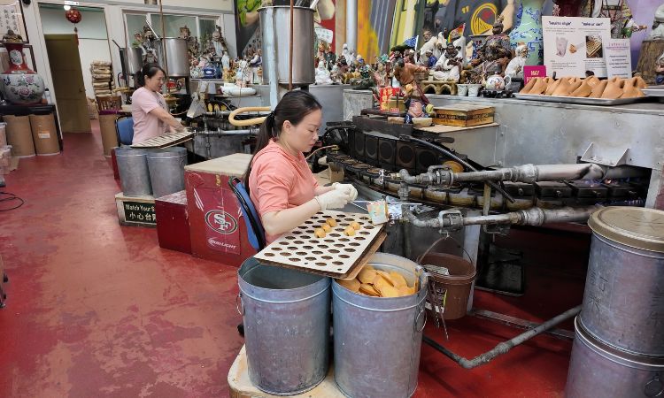 Workers in action at the Golden Gate Fortune Cookie Factory