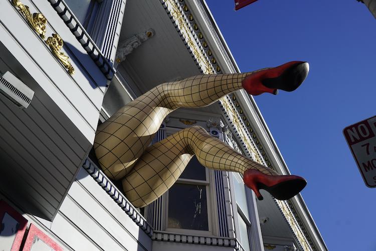 Fishnet legs hanging out the window of the Piedmont Boutique in the Haight-Ashbury