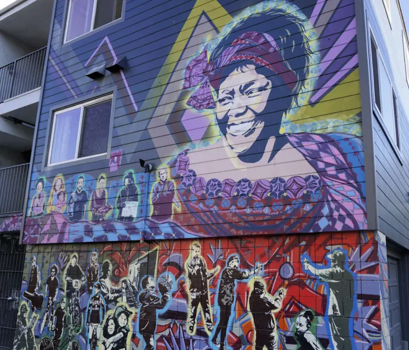 Mural in the side of an apartment building in the Lower Haight