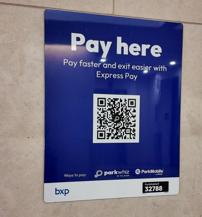 Sign to pay for parking with a QR code.