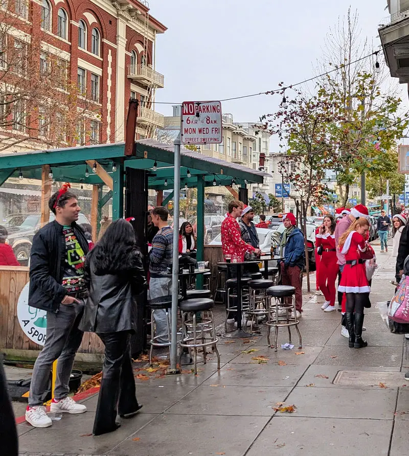 Santas enjoying some drinks at a bar on Polk Street