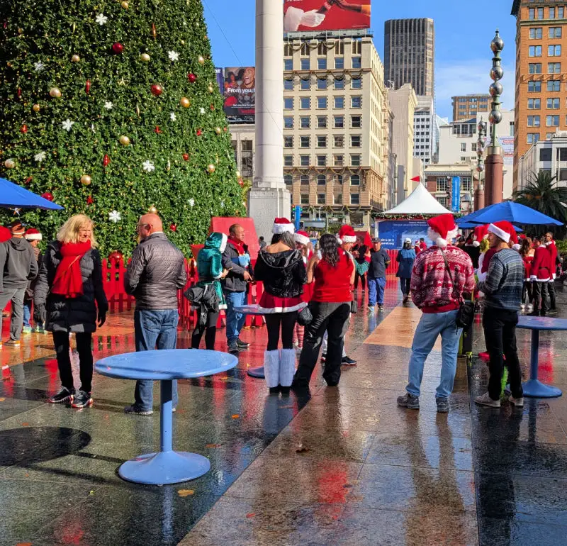 Santas hanging out in Union Square at the start of SantaCon
