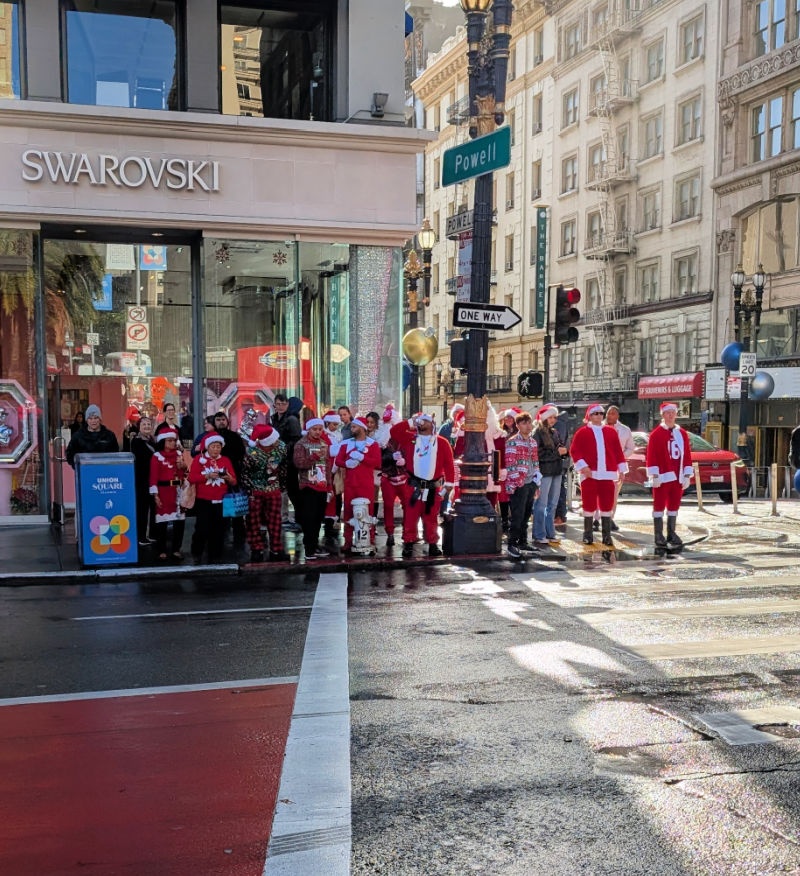 Santacon Santas waiting to cross the street in Union Square