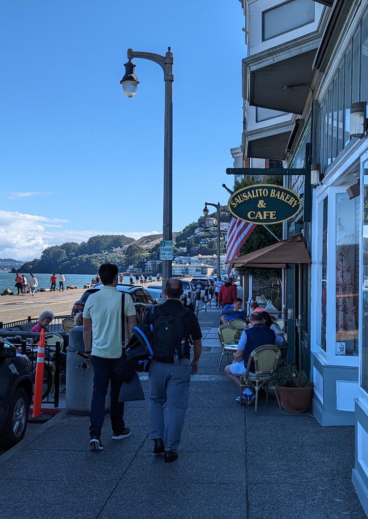 Quaint sidewalk cafes and storefronts facing the SF Bay in Sausalito